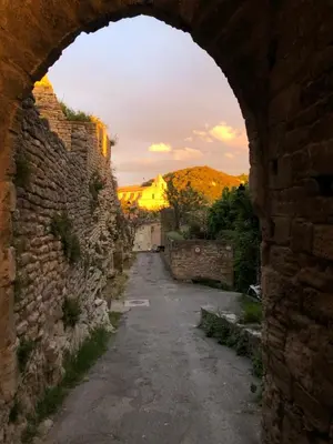 a view of an alley through an archway at Studio 57 à Saignon in Saignon