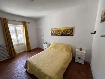 a bedroom with a bed and a painting on the wall at La Figuiere Fontaine de Vaucluse in Fontaine-de-Vaucluse