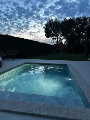 a swimming pool with blue water in a yard at Villa moderne en Provence avec piscine in Carpentras