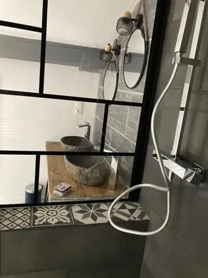 a bathroom with a sink and a shower at Grande terrasse CLIM parking privé SMART TV, local velos in Entraigues-sur-la-Sorgue
