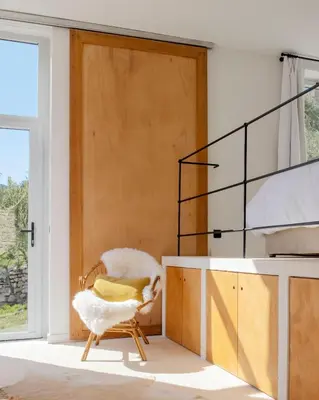 a room with a chair in front of a door at Les Milles Roches in Gordes
