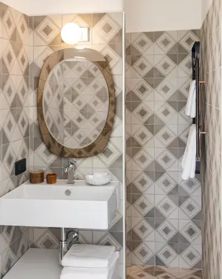 a bathroom with a sink and a mirror at Les Milles Roches in Gordes
