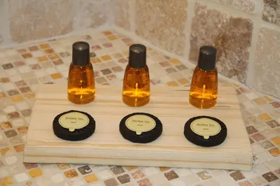 three bottles of essential oils on a wooden board at LE PASSAGE in Lourmarin