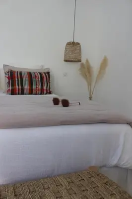 a bedroom with a white bed with glasses on it at Maison Les Chênes in Eygalières