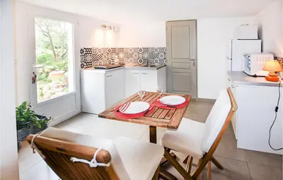a kitchen with a table with two plates on it at Nice Apartment In Caumont-Sur-Durance in Caumont-sur-Durance