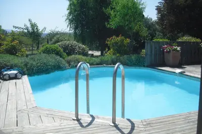 a swimming pool with two metal railings in a yard at Lou mas li Pitchoun 