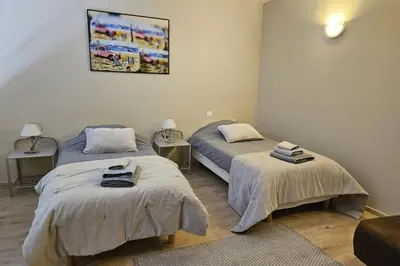 a room with two beds with towels on them at MAS PAPABIOU in Eygalières