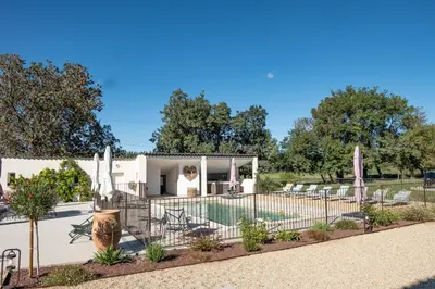 a villa with a pool and a fence at MAS PAPABIOU in Eygalières