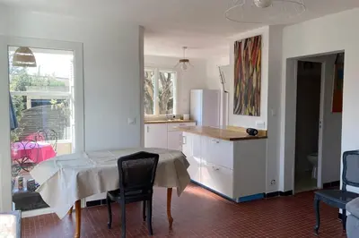 a bedroom with a large bed with a window at Maison Avec jardin clôturé in LʼIsle-sur-la-Sorgue