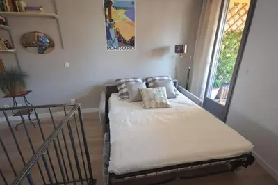 a bed with pillows on it in a room with a window at LE DIX Duplex historical center balcony with view and air conditioning in Aix-en-Provence