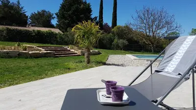 a chair with a pair of purple cups on a table at L’Abrico’thym in Apt