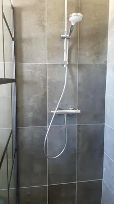 a shower with a hose in a bathroom at L’Abrico’thym in Apt