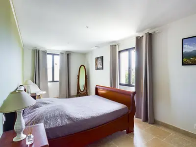 a bedroom with a bed and a lamp and windows at Villa rénovée à Eygalières avec piscine chauffée - FR-1-599-19 in Eygalières