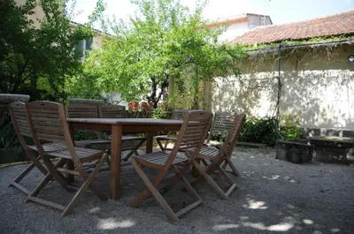 a wooden table with four chairs around it at bastide St Joseph in Eyguières