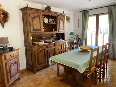 a kitchen with a table and a wooden cabinet at Maison provençale en campagne à Eguilles in Éguilles
