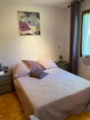 a bedroom with a bed with two pillows on it at Maison provençale en campagne à Eguilles in Éguilles