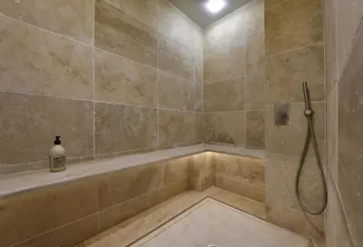 a bathroom with a shower with a tub at La Maison de Lourmarin in Lourmarin