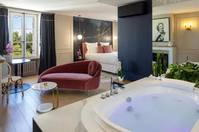 a living room with a tub and a bedroom at La Bastide de Damien, 5 clefs Demeure d'Exception et Table Remarquable dans le guide Teritoria, JACUZZI Privatif, Cuisine étoilée Dominique Frérard in Aix-en-Provence