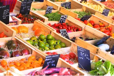 a display of fruits and vegetables in wooden boxes at Maison de village façon Loft, avec cour et airco, dans le centre historique in LʼIsle-sur-la-Sorgue