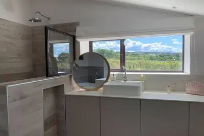 a bathroom with a mirror and a sink and a window at Le Cabanon de Modène version 2021 nature in Modène