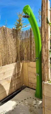 a green archway in front of a wooden fence at Hébergements insolites - Détente en Luberon in Viens