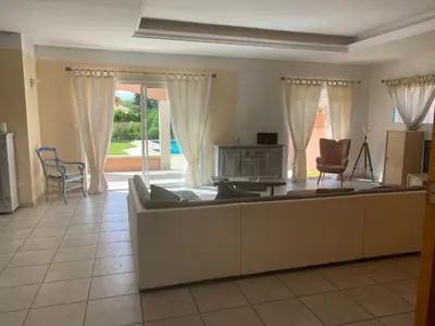 a living room with a couch and a table at Villa et maisonnette provençales in Carpentras