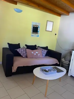 a living room with a couch and a table at Villa et maisonnette provençales in Carpentras