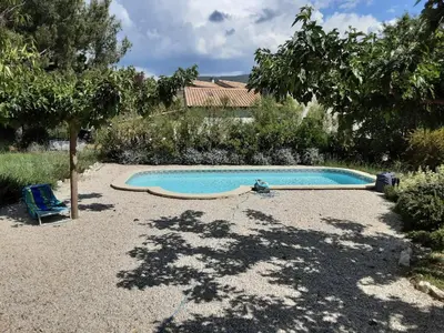 a small swimming pool in a yard with a tree at Le temps des cerises in Méthamis