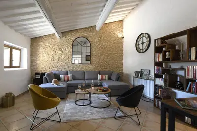 a living room with a couch and chairs and a table at Gite des Demoiselles in Roussillon