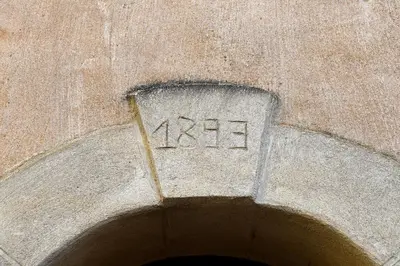 a number on the side of a stone building at Gite des Demoiselles in Roussillon