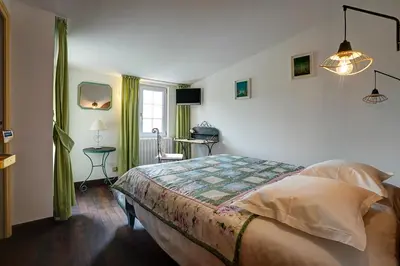 a bedroom with a bed in a room at La Chaumière, Demeure d'hôtes in Lauris
