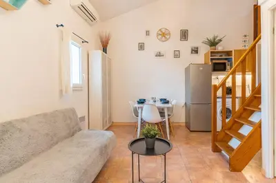a living room with a couch and a table at Le Jardin des Alpilles in Eyguières