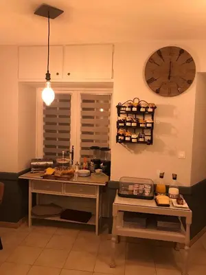 a kitchen with a large clock on the wall at Hostellerie Le Mirabeau in Peyrolles-en-Provence