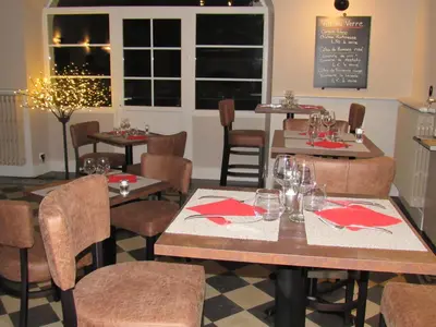 a restaurant with tables and chairs with red napkins at Hostellerie Le Mirabeau in Peyrolles-en-Provence