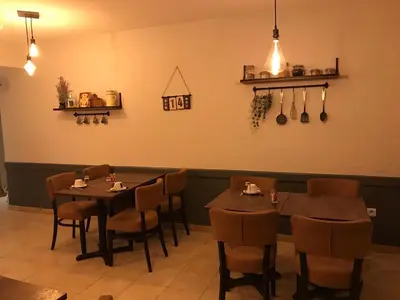 a dining room with two tables and some chairs at Hostellerie Le Mirabeau in Peyrolles-en-Provence