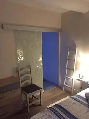 a bedroom with a bed and a desk and a chair at Le jardin in Aix-en-Provence