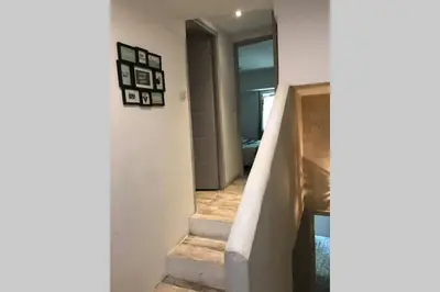 a hallway with a stairway with a stair case at Le jardin in Aix-en-Provence