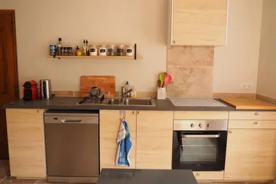 a kitchen with a sink and a stove at Maison Le Grand Verger in Goult