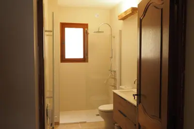 a bathroom with a shower and a toilet and a sink at Maison Le Grand Verger in Goult