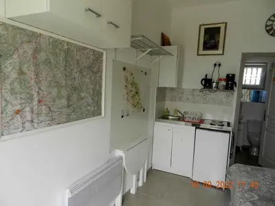a kitchen with a map on the wall and a sink at Chez Mamou & Dadou in Monteux