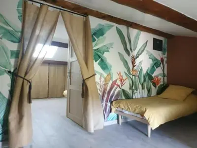 a bedroom with a bed with a flower wall at La ferme des Escampades in Monteux