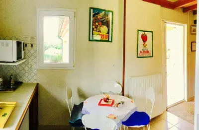 a kitchen with a table and chairs in a room at le vieux pont in Carpentras
