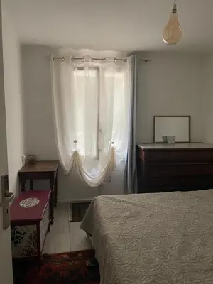 a bedroom with a bed and a dresser and a window at SOUS LE TILLEUL CENTENAIRE in La Tour-dʼAigues