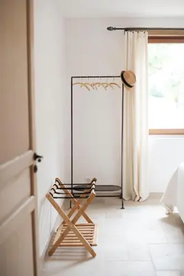 a mirror in a room with a chair next to a window at La Petite Ruche, 1 bedroom Gite in the Luberon in Apt