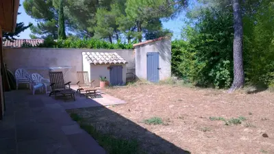 a backyard with chairs and a small shed at Maison charmante à Aix-en-Provence avec piscine privée in Aix-en-Provence