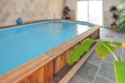 a pool in a room with a wooden swimming pool at Maison charmante à Aix-en-Provence avec piscine privée in Aix-en-Provence