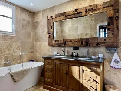 a bathroom with a tub and a sink and a tub and a mirror at Bastide provençale à Murs, coeur du Lubéron in Murs