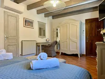 a bedroom with two beds with towels on them at Bastide provençale à Murs, coeur du Lubéron in Murs