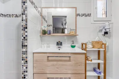 a bathroom with a sink and a mirror at Le Parc in Carpentras