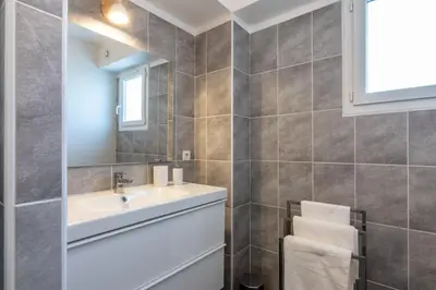 a bathroom with a sink and a mirror at L'Isle Ô Jardin in LʼIsle-sur-la-Sorgue